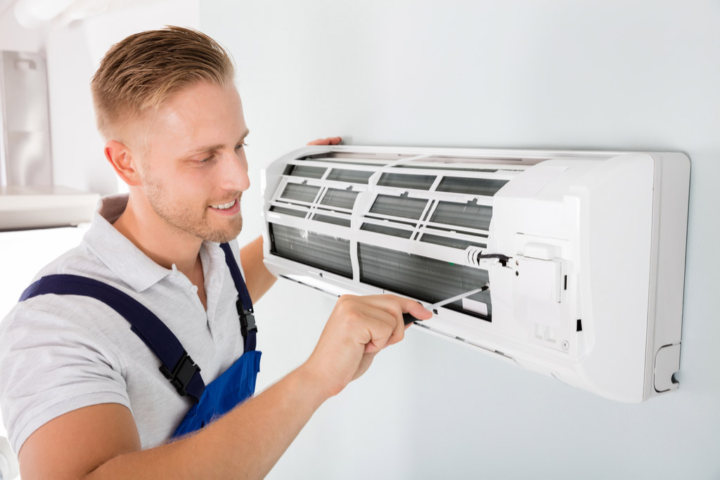 HVAC technician maintaining a ductless air conditioner in Fountain Valley
