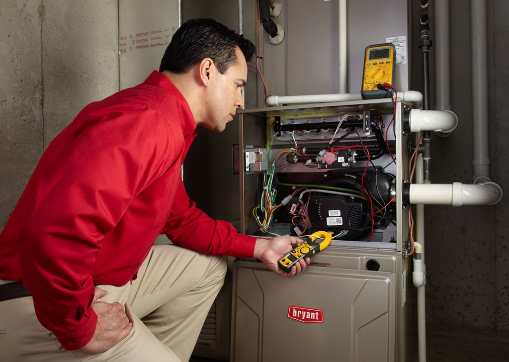 Heating technician diagnosing a furnace repair in Fountain Valley