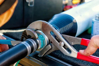 Technician repairing an industrial pipe connection in Fountain Valley