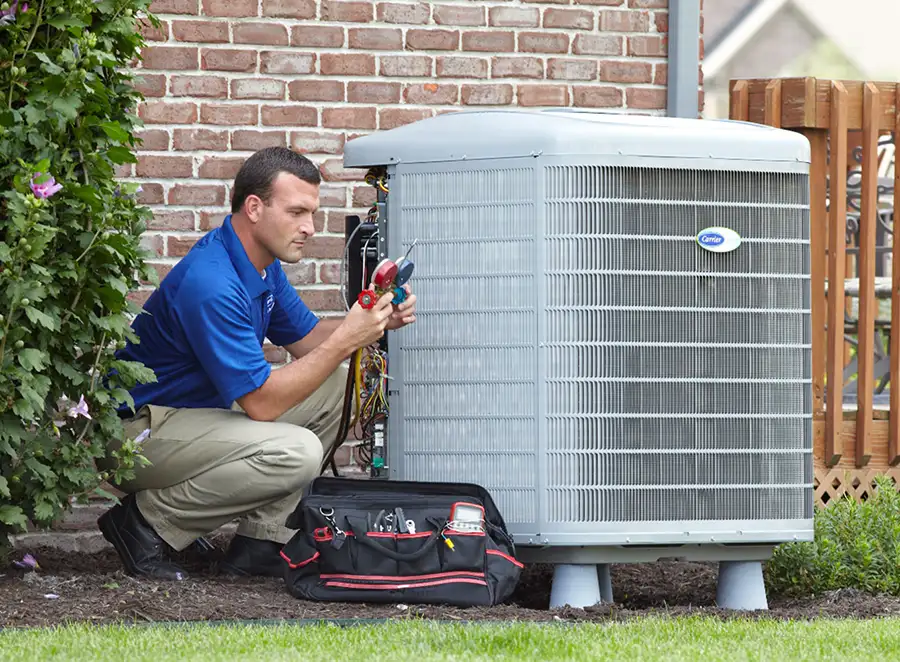 HVAC technician inspecting an outdoor AC unit in Fountain Valley