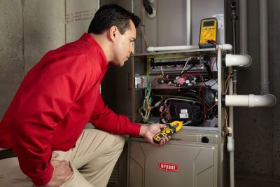 Heating technician diagnosing a furnace repair in Fountain Valley