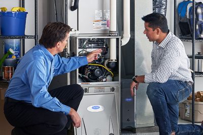 Technician evaluating a furnace for repair or replacement in Fountain Valley