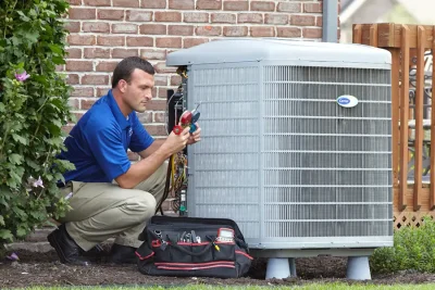 HVAC technician inspecting an outdoor AC unit in Fountain Valley